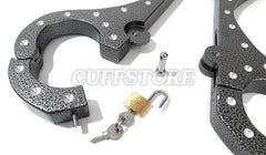 A Heavy Aluminum Cangue with Padlock Bondage Yoke Shrews Fiddle Restraint by The Cuffstore is open, with a padlock and two keys between its halves. The Cuffstore appears subtly in the background.