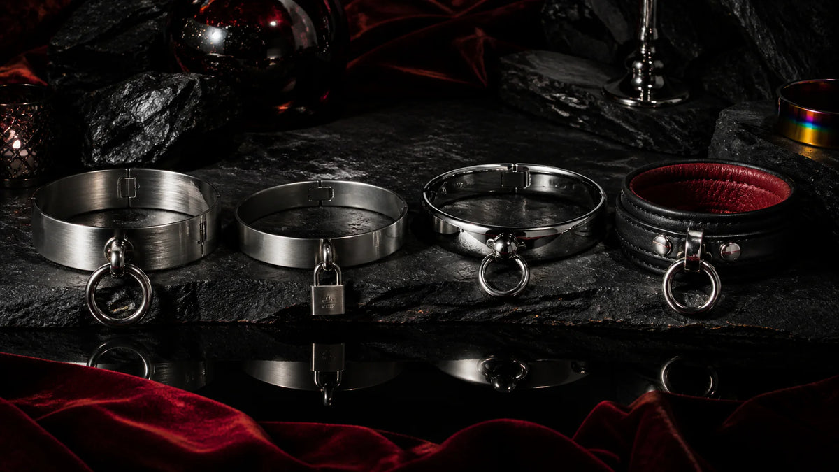 Brushed and polished collars with O-rings and a leather collar on oxblood velvet.
