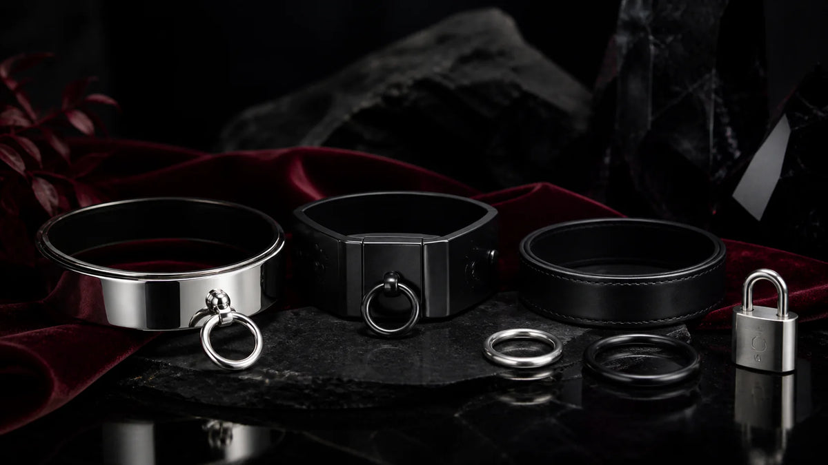 Polished and matte-black collar arcs with O-rings on black stone.