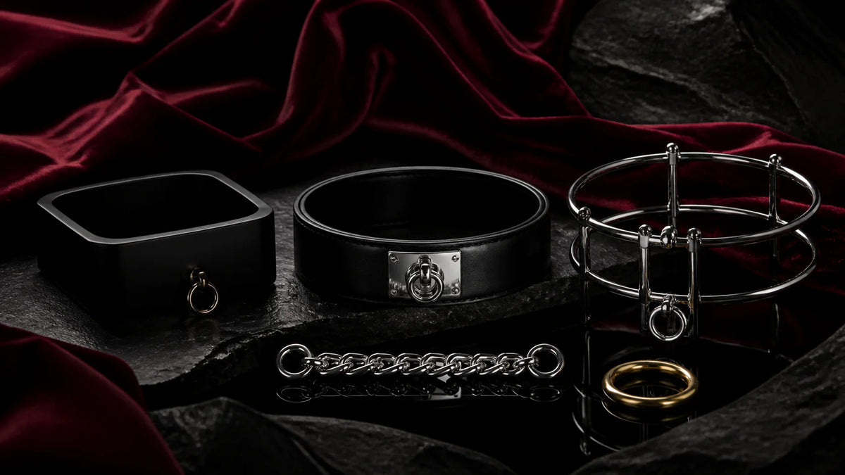 Matte-black and satin chokers with a stainless ring structure on dark stone.