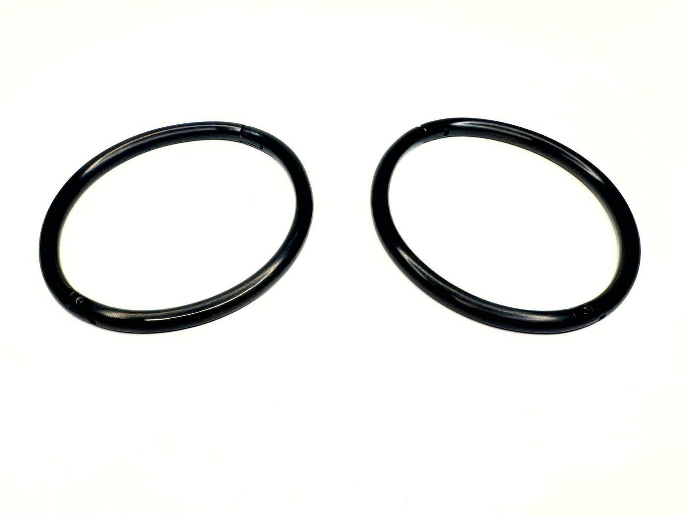 Two NEW 6mm Matte Black Titanium Eternity Cuffs from The Cuffstore are arranged parallel on a plain white background, showcasing the discreet locking anklet/bracelet accessory.